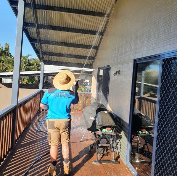 a man washing the ceiling of a house