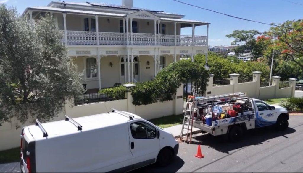 House Washing Heroes ute outside a large Hamilton home after completing a professional house washing service.